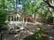 This outdoor gathering space features a fire pit and Adirondack chairs, plus mature landscaping and trees at 1985 Union St, Lakewood, CO 80215
