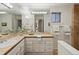 Bathroom features double sinks, marble countertops, and a view into the hallway at 1985 Union St, Lakewood, CO 80215
