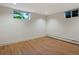 Unfurnished room with wood floors, white walls and baseboards, and two windows for natural light at 1985 Union St, Lakewood, CO 80215