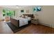 Cozy bedroom with hardwood floors, large windows, and comfortable seating area at 1985 Union St, Lakewood, CO 80215