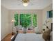 Bright bedroom featuring large window with natural light and green views at 1985 Union St, Lakewood, CO 80215