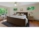 Cozy bedroom with hardwood floors, large windows, and comfortable furnishings at 1985 Union St, Lakewood, CO 80215
