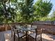 Outdoor deck featuring outdoor dining set with lush tree coverage at 1985 Union St, Lakewood, CO 80215