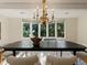 Bright dining room features a large window and modern chandelier at 1985 Union St, Lakewood, CO 80215