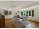 Elegant dining room with hardwood floors, chandelier, and a large bay window overlooking the yard at 1985 Union St, Lakewood, CO 80215