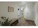 Hallway features neutral walls, tile floor, and a small bench with baskets underneath for storage at 1985 Union St, Lakewood, CO 80215