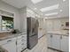 Bright kitchen featuring stainless steel appliances, granite countertops, and skylights at 1985 Union St, Lakewood, CO 80215
