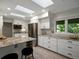 Bright eat-in kitchen featuring white cabinets, stainless appliances, and center island at 1985 Union St, Lakewood, CO 80215