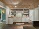 Open-concept kitchenette features a sink, wooden countertops, sleek white cabinetry and track lighting at 1985 Union St, Lakewood, CO 80215