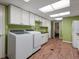 This spacious laundry room has bright cabinets, a large washer and dryer, plus lots of storage and countertop space at 1985 Union St, Lakewood, CO 80215