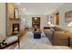 Bright and airy living room with a brick fireplace, hardwood floors, and natural light at 1985 Union St, Lakewood, CO 80215