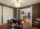 Home office with patterned wallpaper, a modern desk, and french doors leading to living room at 1985 Union St, Lakewood, CO 80215