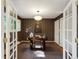 Stylish home office featuring patterned wallpaper, french doors, and contemporary furnishings at 1985 Union St, Lakewood, CO 80215