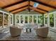 Bright sunroom featuring light colored walls, wood paneled vaulted ceiling, tile floors, and ample windows at 1985 Union St, Lakewood, CO 80215