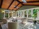 Bright sunroom featuring light colored walls, wood paneled vaulted ceiling, tile floors, and ample windows at 1985 Union St, Lakewood, CO 80215