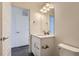 Clean bathroom with white vanity and toilet at 10251 E 62Nd Pl, Denver, CO 80238