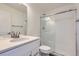 A bathroom with a white vanity, mirror, and modern glass shower enclosure features contemporary fixtures at 10251 E 62Nd Pl, Denver, CO 80238