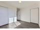 Bedroom showcasing gray floors, white walls, and sliding door closet at 10251 E 62Nd Pl, Denver, CO 80238