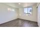 Sun-filled bedroom featuring hardwood-style flooring, a large window, and a contemporary design with closet space at 10251 E 62Nd Pl, Denver, CO 80238