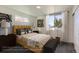 Stylish bedroom featuring a comfortable bed, modern lighting, and window with natural light at 10251 E 62Nd Pl, Denver, CO 80238