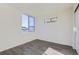 Spacious bedroom with grey floor and large window at 10251 E 62Nd Pl, Denver, CO 80238