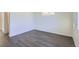 Bright bedroom with grey wood-look floors and large closet at 10251 E 62Nd Pl, Denver, CO 80238