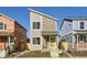 Two-story modern home with gray siding, yellow porch, and landscaping at 10251 E 62Nd Pl, Denver, CO 80238