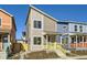 Two-story modern home with gray siding, yellow porch, and landscaping at 10251 E 62Nd Pl, Denver, CO 80238