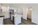 Modern kitchen with stainless steel appliances, island and white cabinets, open to living area at 10251 E 62Nd Pl, Denver, CO 80238