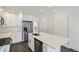 Bright kitchen features stainless steel appliances, white cabinets, and a large island with a sink at 10251 E 62Nd Pl, Denver, CO 80238