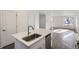 Modern kitchen island with sink and stainless steel dishwasher at 10251 E 62Nd Pl, Denver, CO 80238