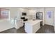 Modern kitchen with white cabinets, stainless steel appliances, and an island at 10251 E 62Nd Pl, Denver, CO 80238