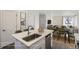 Bright, functional kitchen with island seating that flows into the dining and living areas at 10251 E 62Nd Pl, Denver, CO 80238