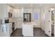 Modern kitchen with white cabinets, a center island, and stainless steel appliances provides a seamless design at 10251 E 62Nd Pl, Denver, CO 80238