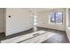 Bright living room with gray vinyl plank flooring and large windows at 10251 E 62Nd Pl, Denver, CO 80238