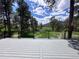Inviting back deck overlooks the lush greenery and serene natural landscape at 14546 Pine View Rd, Larkspur, CO 80118