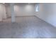Large basement area features neutral carpet and ample lighting and a window at 14546 Pine View Rd, Larkspur, CO 80118