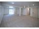 Large basement with neutral carpet, white walls, and multiple doors, offering ample living or storage space at 14546 Pine View Rd, Larkspur, CO 80118