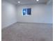 Spacious carpeted basement area with a window allowing natural light to enter the room at 14546 Pine View Rd, Larkspur, CO 80118