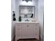 Stylish bathroom vanity with drawers and large mirror, plus modern fixtures at 14546 Pine View Rd, Larkspur, CO 80118