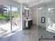 Modern bathroom featuring a vanity, mirror, glass shower, and sliding glass door to the outdoors at 14546 Pine View Rd, Larkspur, CO 80118