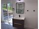 Bathroom featuring modern vanity and glass door leading to exterior with forest view at 14546 Pine View Rd, Larkspur, CO 80118