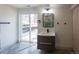 Modern bathroom with sliding glass doors to the outside, stylish vanity, and sleek fixtures and decor at 14546 Pine View Rd, Larkspur, CO 80118