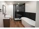 Modern bathroom with a freestanding tub, glass shower, and sleek vanity at 14546 Pine View Rd, Larkspur, CO 80118
