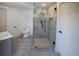 Modern bathroom featuring a glass shower with gray tile surround and gray tile flooring at 14546 Pine View Rd, Larkspur, CO 80118