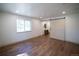 Bedroom with wood floors and barn door entrance to ensuite bathroom at 14546 Pine View Rd, Larkspur, CO 80118
