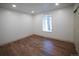 Bedroom with wood floors, recessed lighting, and a window with backyard views at 14546 Pine View Rd, Larkspur, CO 80118