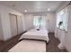 Bright bedroom with hardwood floors, a fluffy rug, and abundant natural light at 14546 Pine View Rd, Larkspur, CO 80118