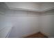 Walk-in closet with white shelves and rods for plenty of storage at 14546 Pine View Rd, Larkspur, CO 80118