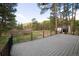 Expansive deck offers serene views of the surrounding lush trees, with ample space for outdoor enjoyment at 14546 Pine View Rd, Larkspur, CO 80118